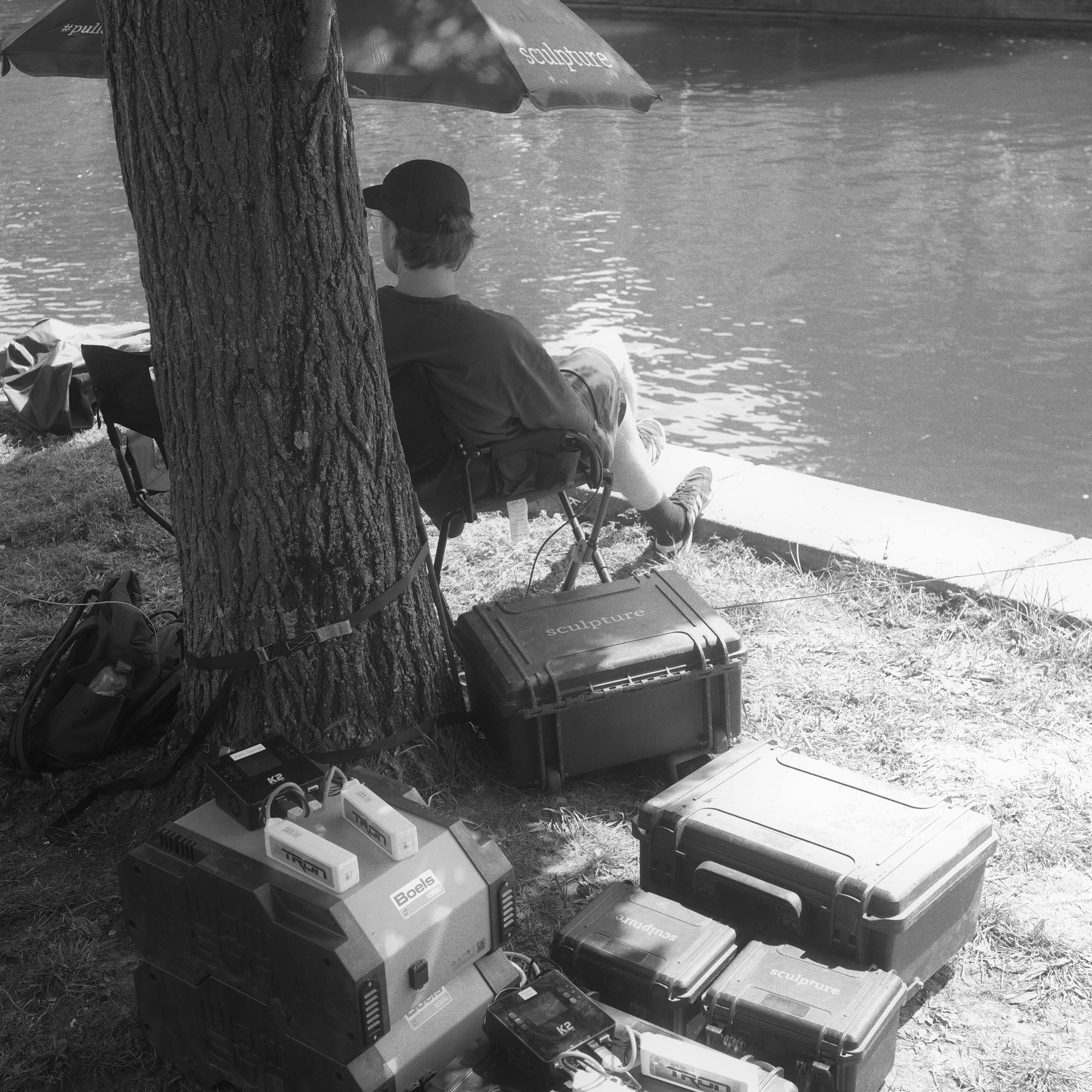 Operator on standby by the water with Sculpture cases