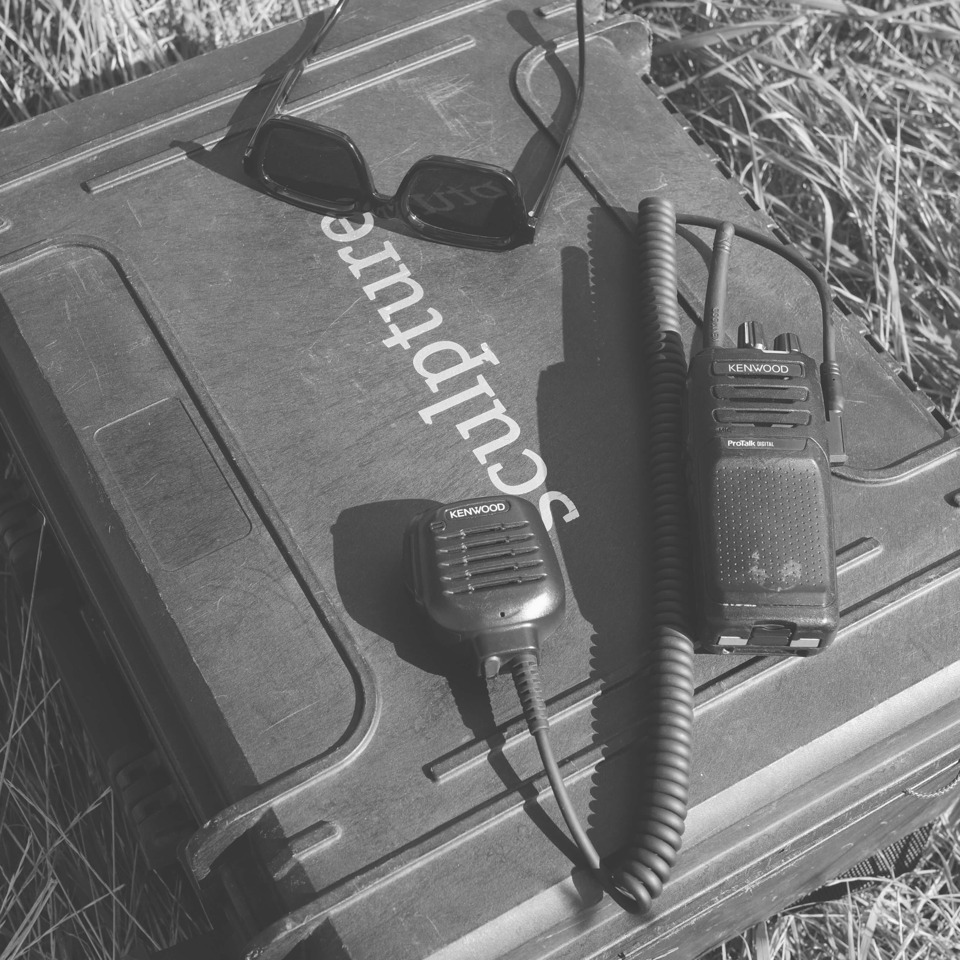 Radios and gear staged on a Sculpture case